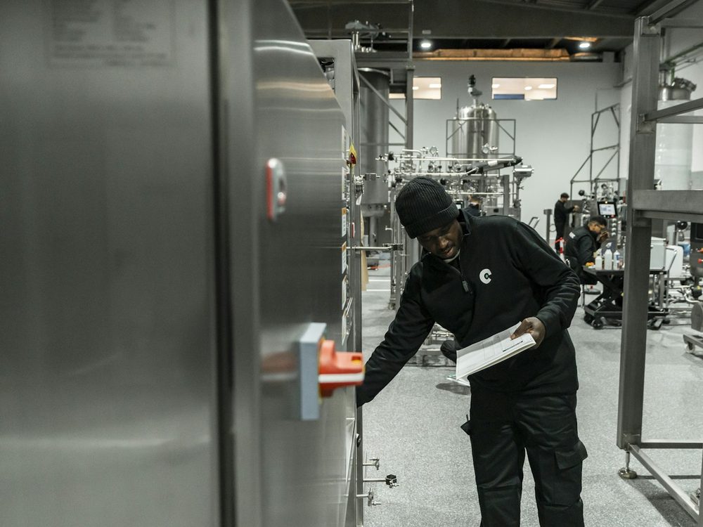 Technician inspecting process equipment in a modern factory
